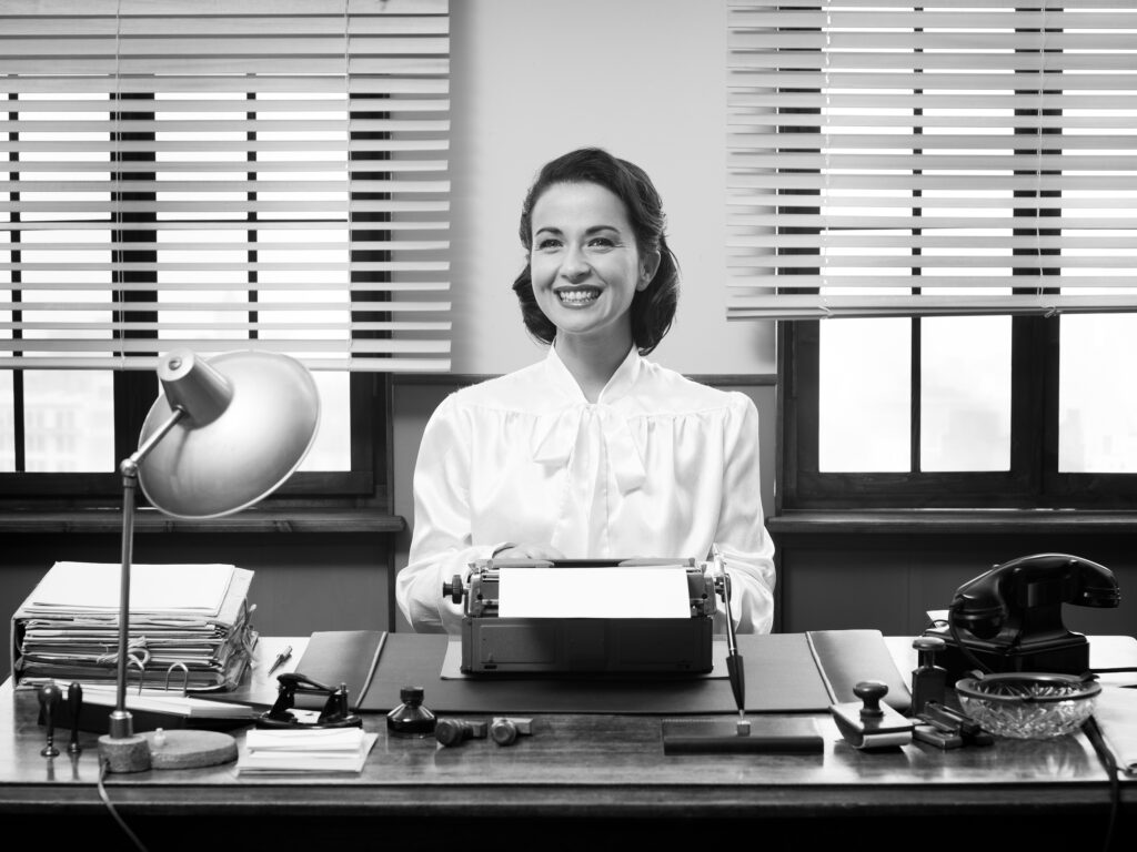 bigstock-Cheerful-Vintage-Secretary-76865525-1024x768.jpg